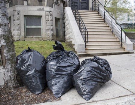 Workers wearing PPE while handling bulky waste items